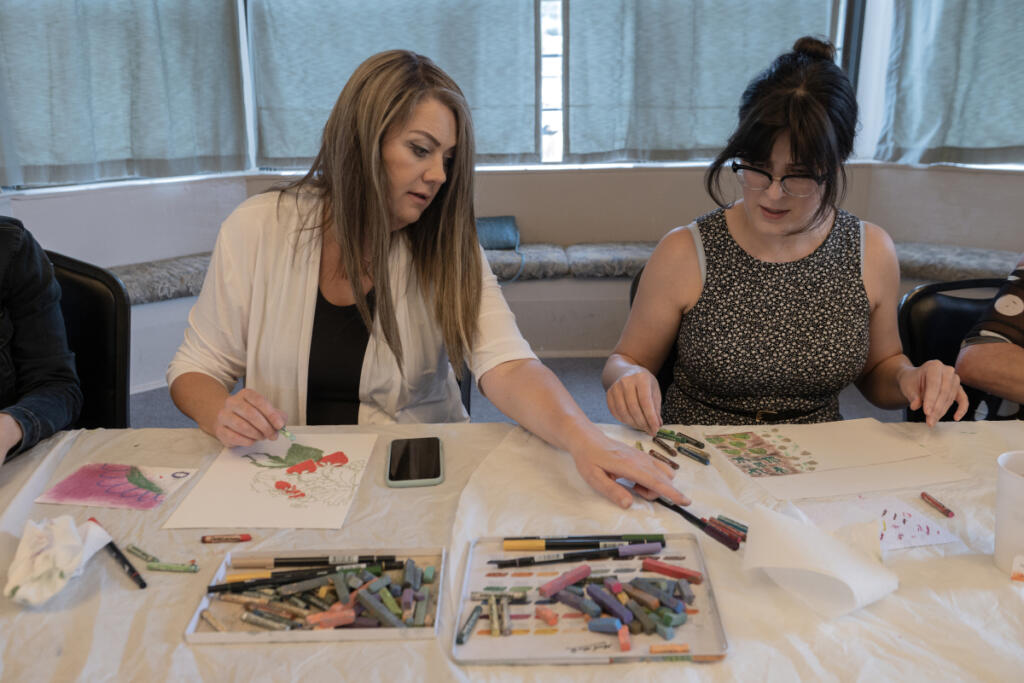 Jennifer Lenhardt of Oregon City, Ore., left, joins Erika Patterson of Camas Sept. 1 at Memory Garden, a monthly art meet-up for adults. Participants recreate positive memories through different art projects using a variety of prompts and materials. (Photos by Amanda Cowan/The Columbian)