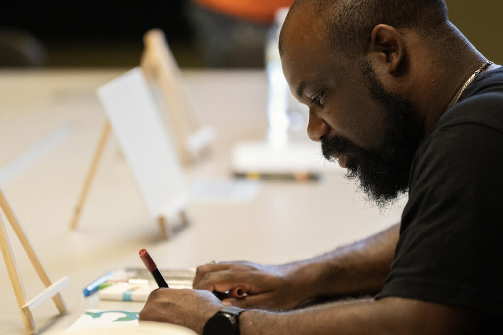 Gentle Strength Project leader David Bradley paints Sept. 3 during a Gentle Strength Project paint night at Vancouver Community Library. The Gentle Strength Project promotes friendships between men and encourages discussing mental heath. (Taylor Balkom/The Columbian)