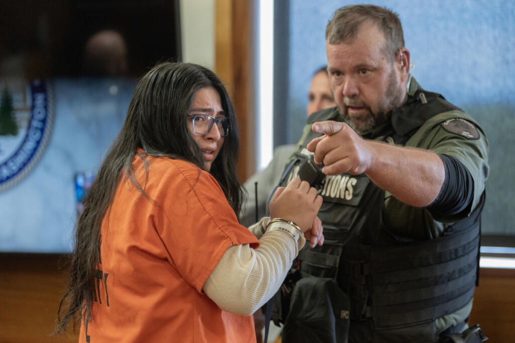 Helena Villa-Rodriguez, left, prepares to leave the courtroom after sentencing in Clark County Superior Court on Sept. 23. (Amanda Cowan/The Columbian)