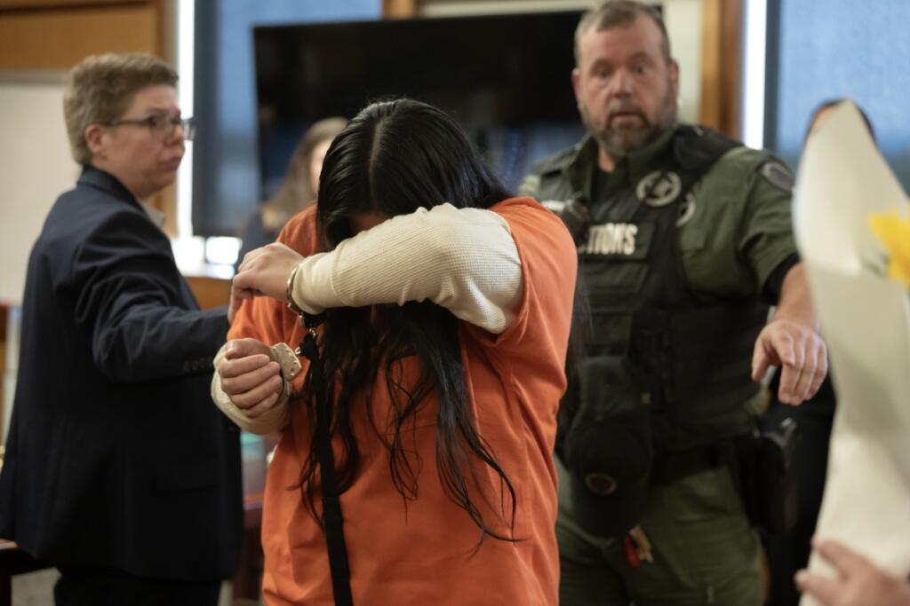Helena Villa-Rodriguez, center, leaves the courtroom after sentencing as a person in the gallery tries to give her a flower in Clark County Superior Court on Wednesday afternoon. A jury convicted Villa-Rodriguez of first-degree attempted murder, first-degree assault and drive-by-shooting for shooting her former boyfriend March 21, 2024. (Amanda Cowan/The Columbian)