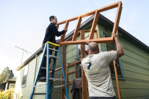 Craftsmen Jeramy Boik, left, and Michael Jaeger of Vancouver-based Catio Craftsman install a catio roof for a client Thursday in Northeast Portland. Adding a catio can help keep cats safe and reduce predation on birds and other wildlife. (Photos by Taylor Balkom/The Columbian)