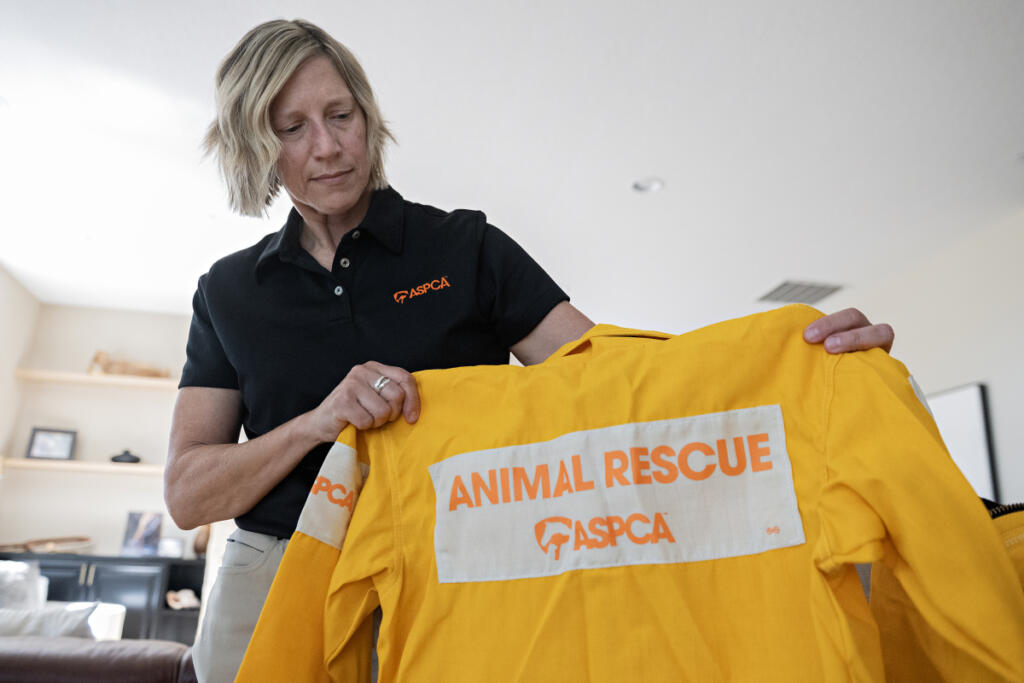 Susan Anderson, senior director of disaster response for the American Society for the Prevention of Cruelty to Animals, looks over some of the gear she uses in the field while relaxing at her Vancouver home Sept. 16.
