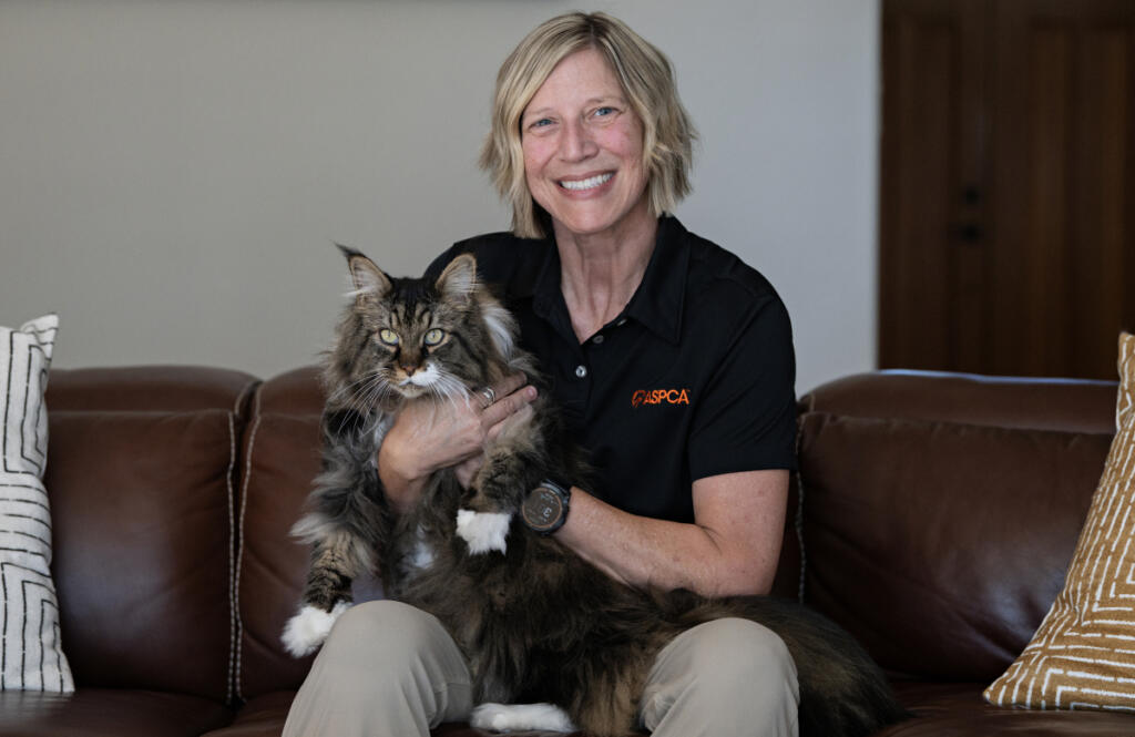 Susan Anderson, senior director of disaster response for the American Society for the Prevention of Cruelty to Animals, relaxes at her Vancouver home with her kitty, Bronto, 10, on Sept. 16. (Amanda Cowan/The Columbian)