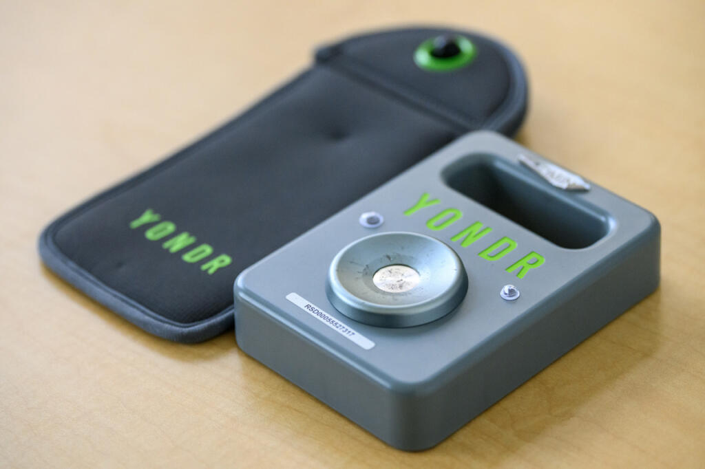 A Yondr device pouch and unlock mechanism sit on a table Monday at View Ridge Middle School. (Taylor Balkom/The Columbian)