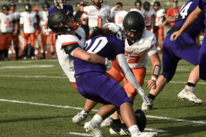 Washougal defender Silas Ellsworth, left, knocks the ball loose from Heritage running back Toa Vaa-Leiataua on Friday at McKenzie Stadium. (Micah Rice/The Columbian)
