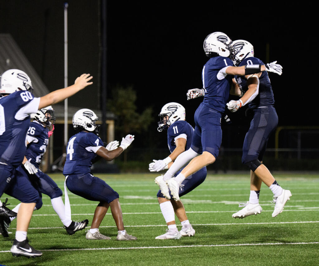 Skyview players storm the field to celebrate Sept. 18 after beating Camas 38-21 at Kiggins Bowl. (Photos by Taylor Balkom/The Columbian)