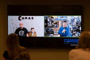 Earthbound former science teacher Dale Croswell, left, and student Miles Nichols chat from Camas with astronaut Dr. Michael Barratt as he travels aboard the International Space Station in May 2024. (The Columbian files)