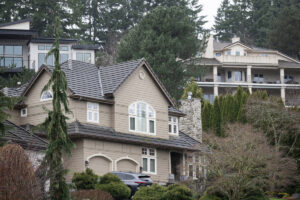 Expensive homes dot a hillside near Camas Meadows Golf Club on Feb. 18 along Lacamas Lake in Camas. More high-income earners have moved out of the county than into it since the COVID-19 pandemic. (Taylor Balkom/The Columbian files)