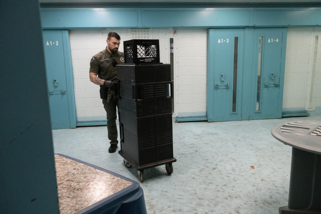 Officer Dante Lopez delivers lunch to inmates in the administrative segregation and suicide watch area of the Clark County Jail on June 2. Voters will decide Nov. 3 on a bond measure to fund expansion of the jail and a levy lid lift to add corrections officers and other criminal justice services.