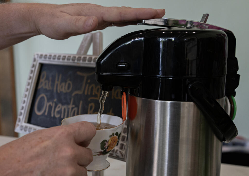 Sonya Tuter pours a cup of tea at her first brick-and-mortar store, Savor & Steep, in Washougal Sept. 23. Customers can sample the featured tea or ask to taste another variety that piques their interest. (Amanda Cowan/The Columbian)