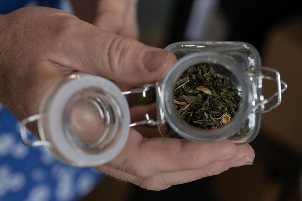 Sonya Tuter displays loose-leaf Earl Grey green tea at Savor & Steep tea shop in Washougal. (Amanda Cowan/The Columbian)