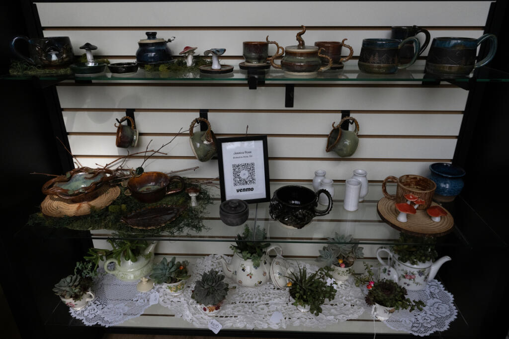 Ceramics by local artist Jessica Rose are seen on display Sept. 23 at Savor & Steep in Washougal. On the bottom shelf are succulent arrangements in teacups by Jamie Zilke. (Amanda Cowan/The Columbian)