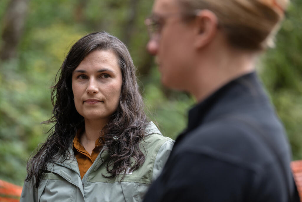 Evelyn Ives, left, and Kaley McLachlan-Burton of Clark County Public Works discuss how the old rail car bridge in Lacamas Regional Park is being replaced.