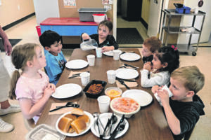 Children gather for lunchtime at the Battle Ground Early Learning Center on Monday morning. (Photos By Amanda Cowan/The Columbian)