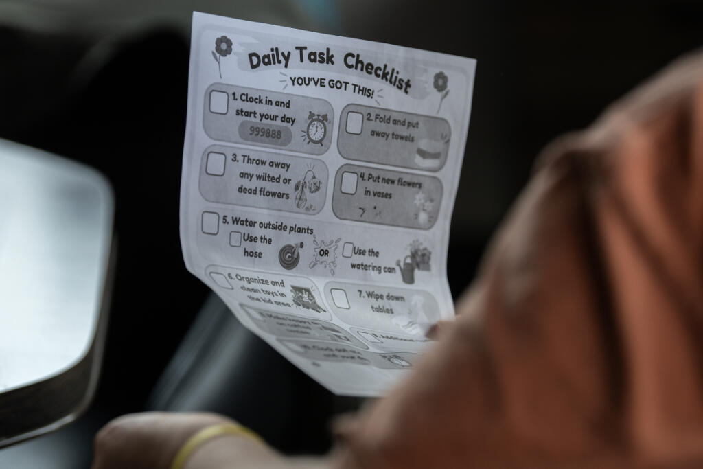 Emily Glenn of Vancouver looks over her list of tasks for Radiate Coffee and Community in Camas on Wednesday morning. (Amanda Cowan/The Columbian)