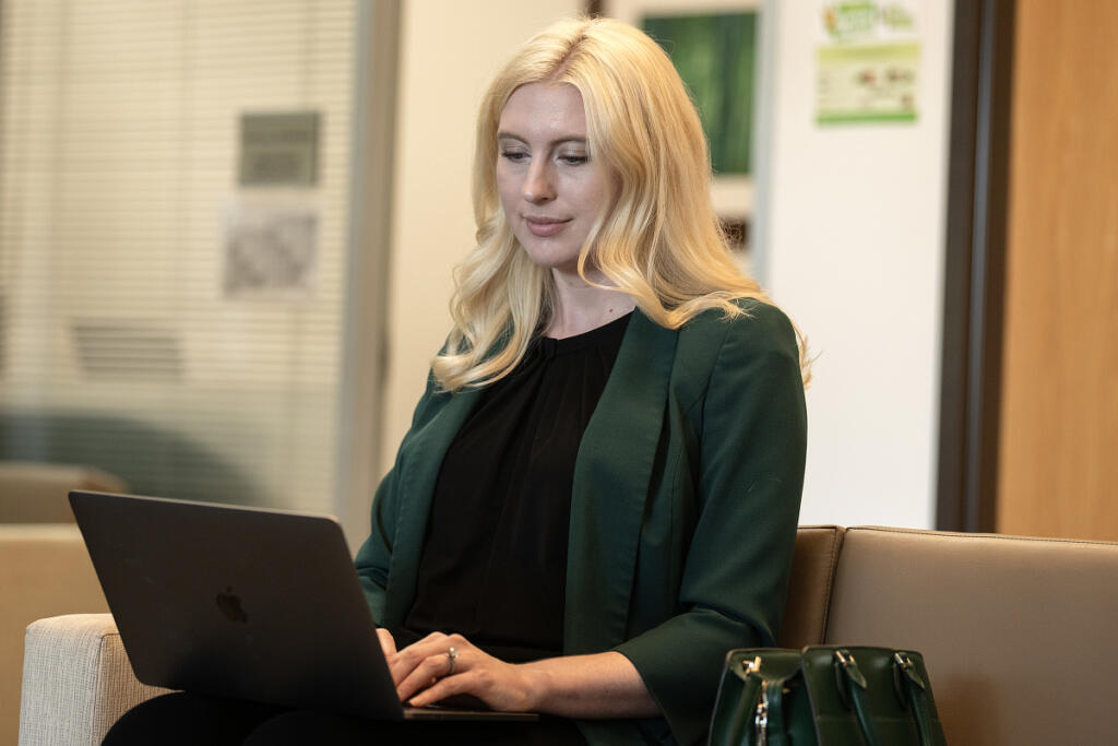 Nurse practitioner Tori Norman works on her laptop before filming an informational video about menopause at Vancouver Clinic on Friday morning. (Amanda Cowan/The Columbian)