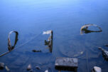 The remnants of a barrel sit on the shore Tuesday at Round Lake in Camas. (Taylor Balkom/The Columbian)