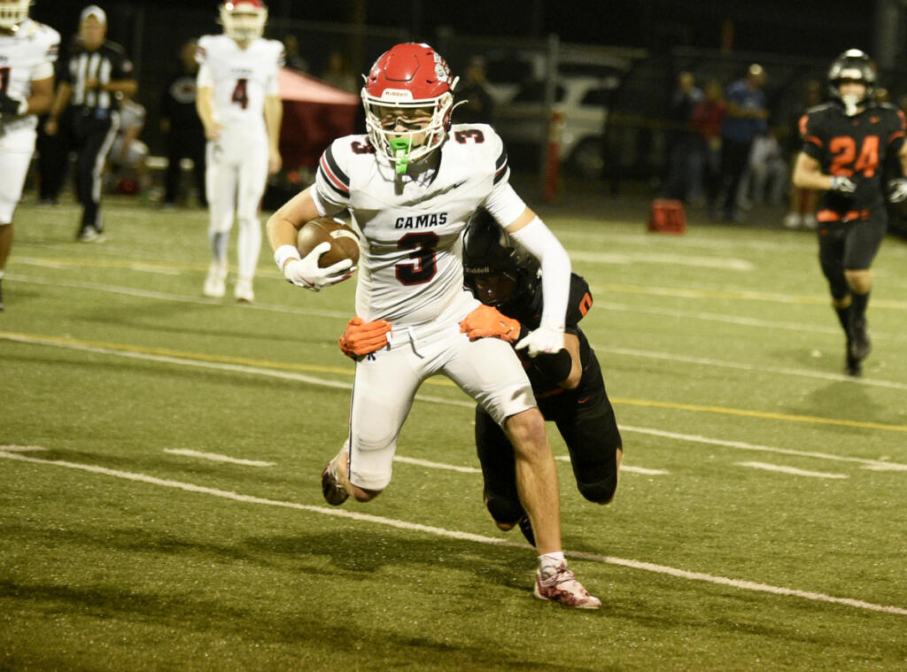 Camas receiver Maxwell Gibson fights for yardage against Battle Ground on Friday at District Stadium. (Micah Rice/The Columbian)