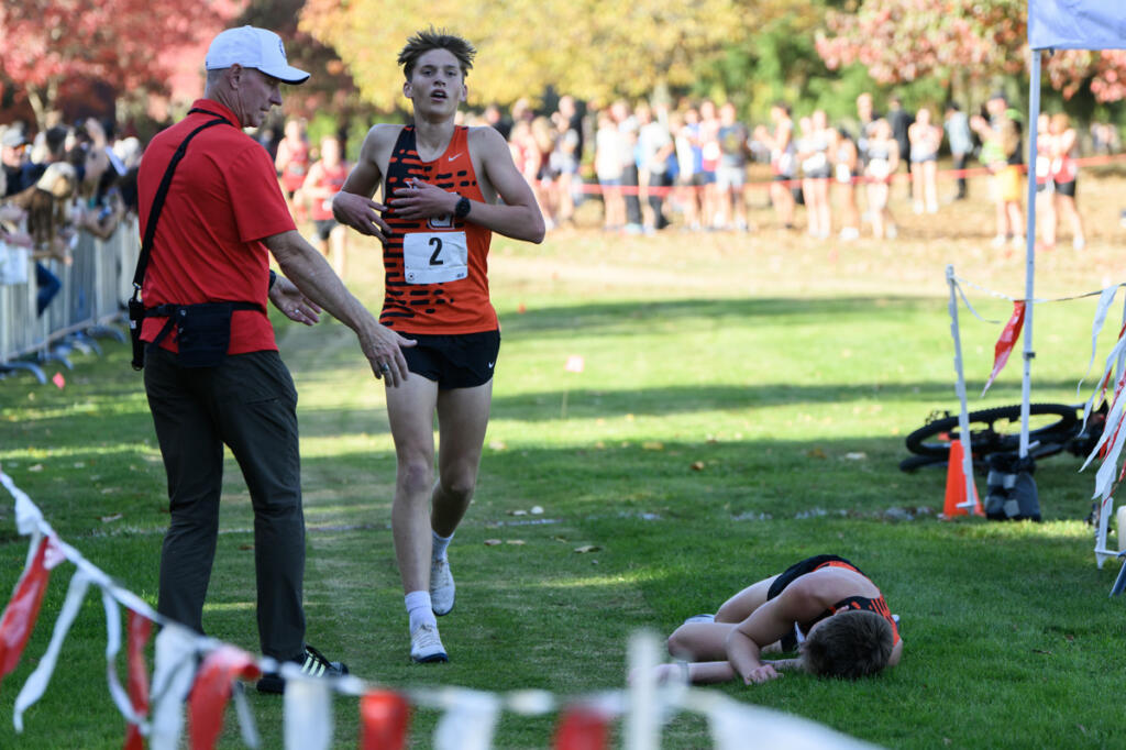 Battle Ground junior Vance Copper, left, finishes the boys race in second behind his brother Trae Copper, on ground at right, on Wednesday, Oct. 1, 2026, during the 4A GSHL District Meet at UL Campus in Camas. (Taylor Balkom/The Columbian)